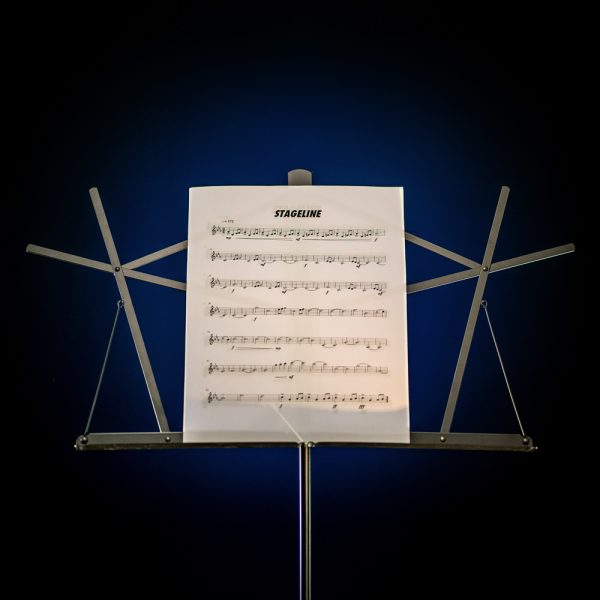 Closeup of top of Stageline music stand holding sheet music