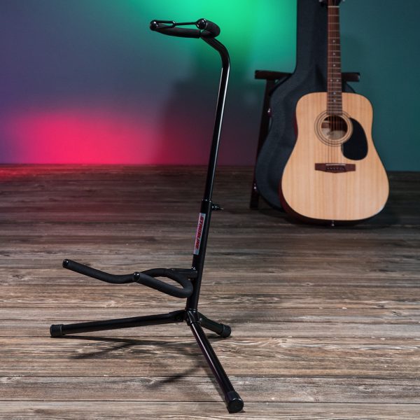 Stageline guitar stand with acoustic guitar and case in background